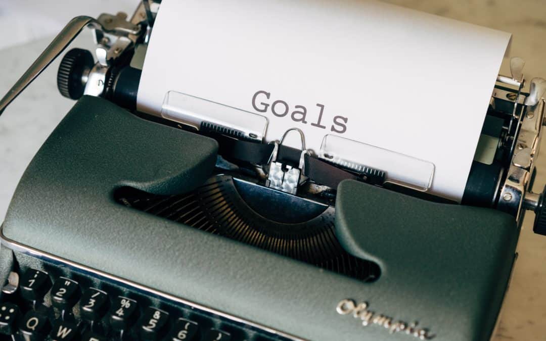 A sheet of paper is in a typewriter, and has the word "Goals" written on it.